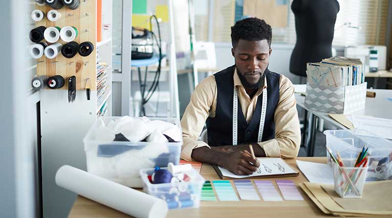 clothing designer working at a desk.