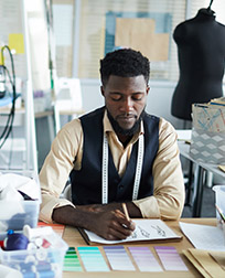 clothing designer working at a desk.