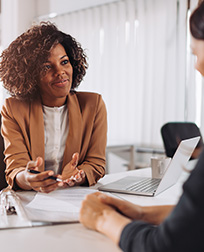 tax preparer at desk with client.