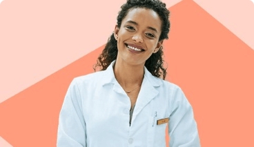 Woman in lab coat smiling on orange background. 