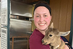 Penn Foster Vet Tech Student holding animal.