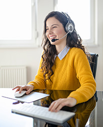 virtual assistant with headset works at her desk.
