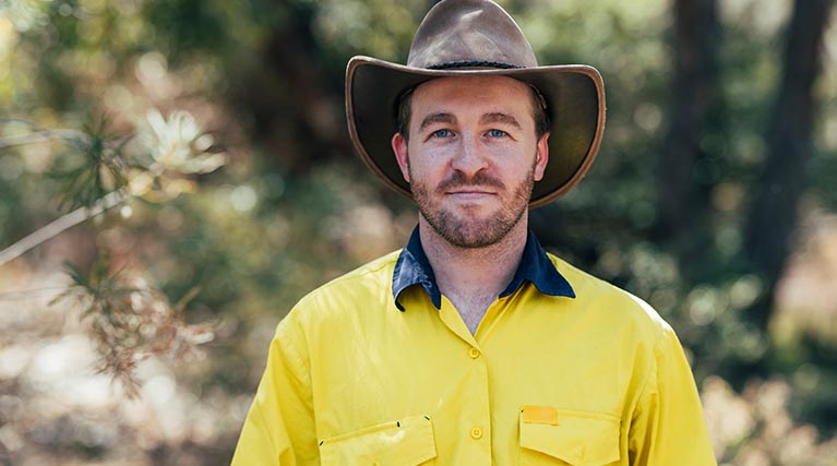 wildlife and forestry professional standing outside.